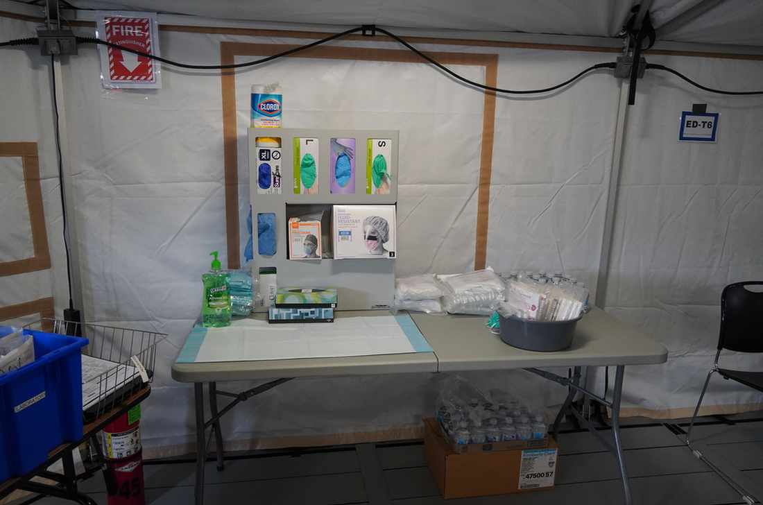 Mask station inside emergency department tent