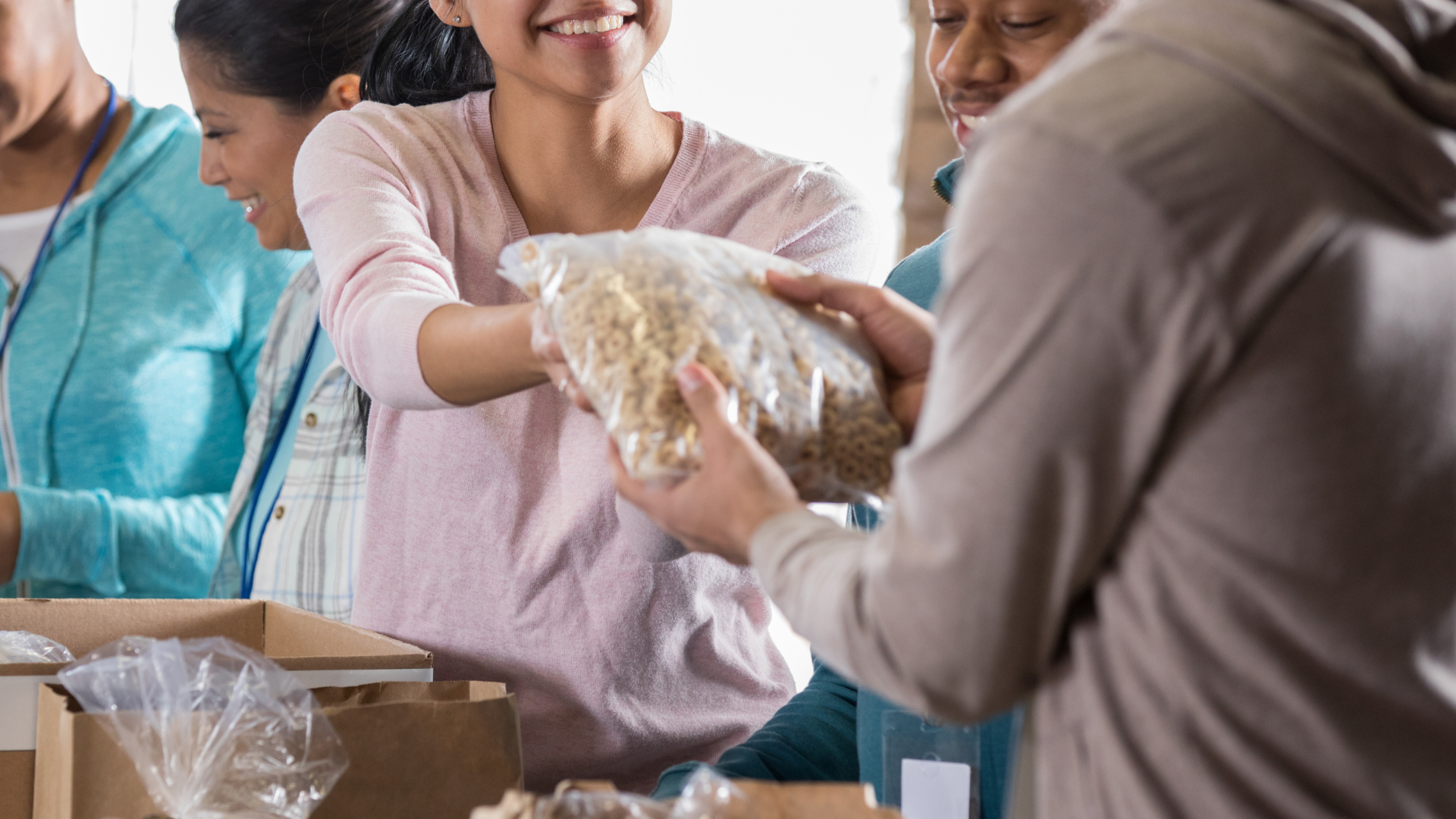 woman handing person cereal bag